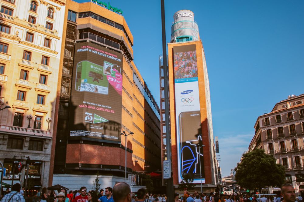 Brand billboards lit up over a city street