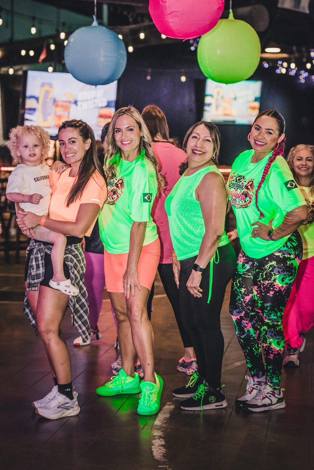 Friends in neon outfits at the Zumba Glow in the Dark Party